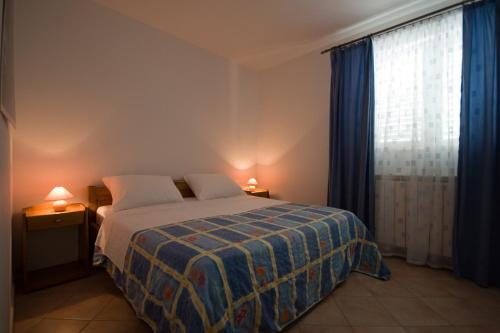 a bedroom with a bed and a large window at Sunny Adriatic apartments Valentin in Vrsar