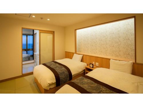 a hotel room with two beds and a window at KAISYU - Vacation STAY 42706v in Kyotango