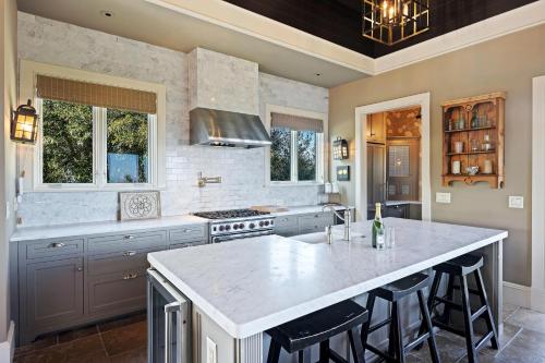 a kitchen with a large island with bar stools at 9 2nd Avenue in Isle of Palms