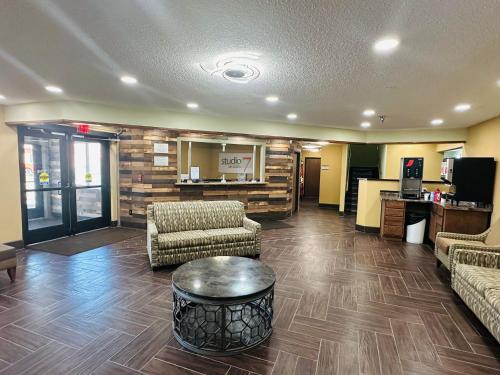 a lobby with couches and a table in a room at Studio 7 on Main in West Fargo