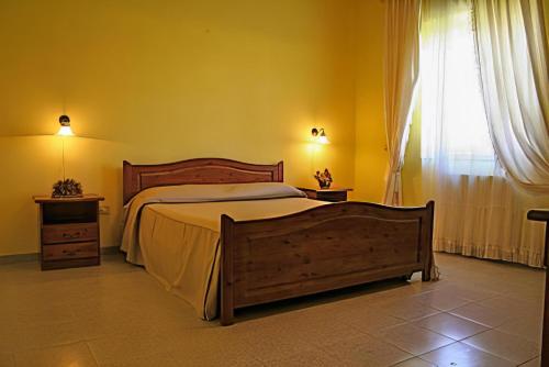 a bedroom with a large bed and a window at Villa Fiorita in Casal Velino