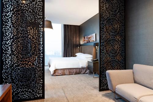 a hotel room with a bed and a mirror at Hilton Mexico City Santa Fe in Mexico City