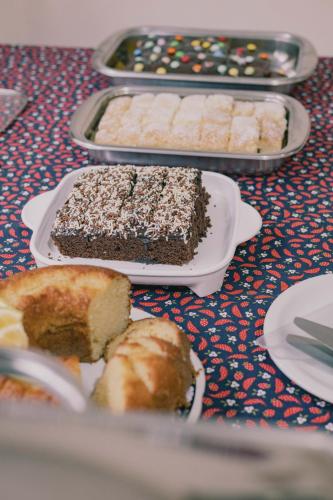 a table topped with different types of cakes and pastries at Pousada Café in Torres