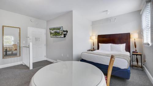 a hotel room with a bed and a table at Crystal Bay Historic Hotel in St Petersburg
