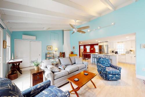 a living room with a couch and a table at Sea and Be in West Yarmouth