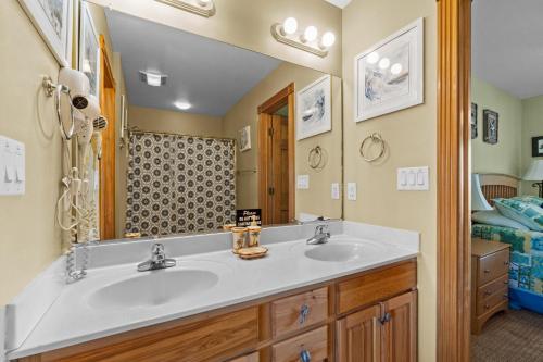 a bathroom with a sink and a mirror at 5711 - OBX Ta SEA by Resort Realty in Nags Head