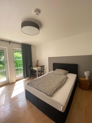 a bedroom with a large bed and a table at Apartment, Monteurswohnung in Worms in Worms