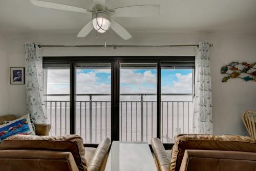 a living room with a ceiling fan and a large window at Gulf Tower 3C by Vacation Homes Collection in Gulf Shores