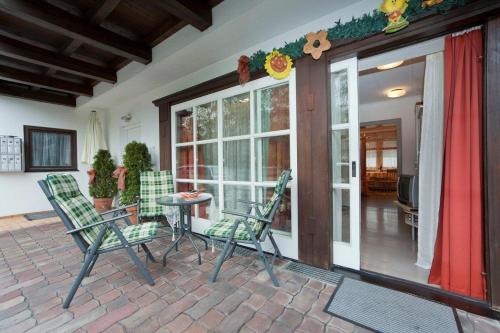 a patio with chairs and a table in front of a house at Ferienwohnung Pali in Sankt Johann in Tirol