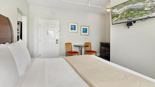 a bedroom with a bed and a flat screen tv at Crystal Bay Historic Hotel in St Petersburg