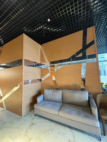 a living room with a couch and chairs in it at New Wave Apart-Hotel in Batumi