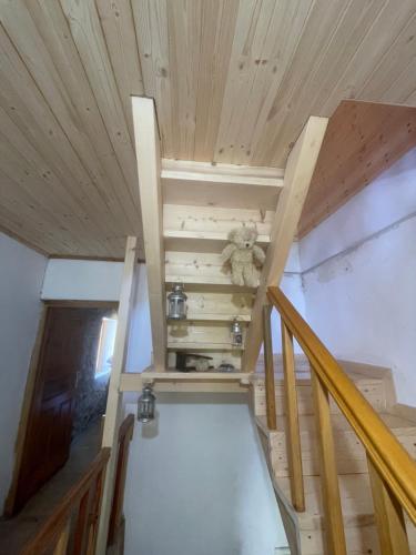 a staircase in a tiny house with a teddy bear at Rupa Guest House in Theth
