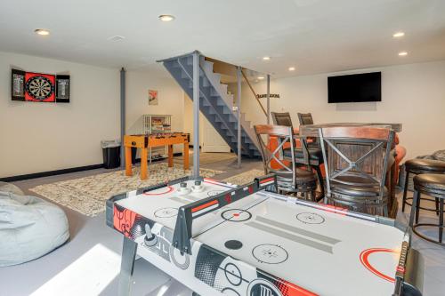 a living room with a ping pong table and chairs at 6 Mi to Mt Snow Nature-View Home with Fire Pit! in West Dover