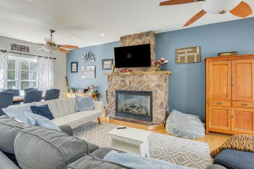 a living room with a couch and a fireplace at 6 Mi to Mt Snow Nature-View Home with Fire Pit! in West Dover