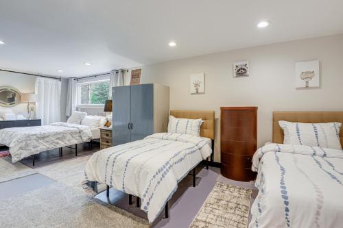 a bedroom with two beds and a mirror at 6 Mi to Mt Snow Nature-View Home with Fire Pit! in West Dover