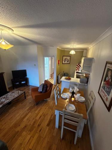 a kitchen and living room with a table and chairs at 29 Cill Ard Bohermore Galway City in Galway