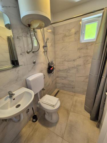 a bathroom with a toilet and a sink at Old Town Residence in Sarajevo