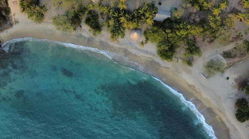 an overhead view of a beach with turquoise water at Wachakyta Ecolodge in Calabazo