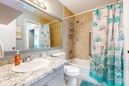 a bathroom with a sink and a toilet and a shower at Centrally located dog-friendly home with beach gear & patio - snowbird-friendly in Palm Coast