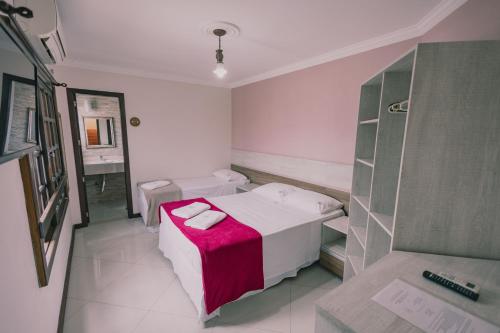 a small hospital room with a bed and a mirror at Pousada Café in Torres