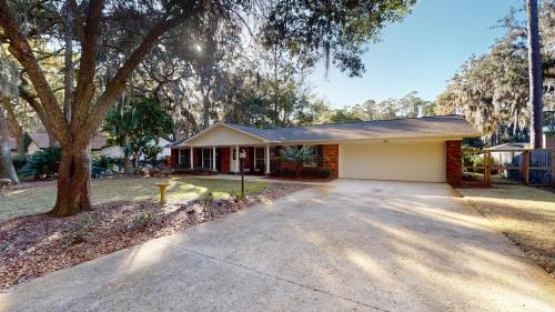 a house with a tree and a driveway at A LIFELONG DREAM home in Jekyll Island