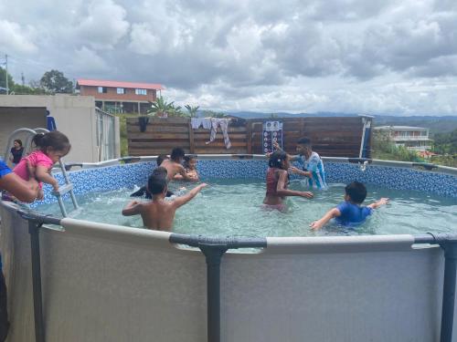 a group of children playing in a swimming pool at Finca Villa Mariana in Papagalleros