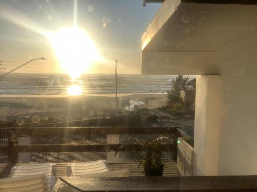 a view of the ocean from the balcony of a house at Pousada Beira Mar - Suítes Frente ao mar in Torres
