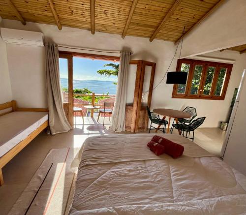a bedroom with a bed and a view of the ocean at Casa Tuco - Cumuruxatiba in Cumuruxatiba
