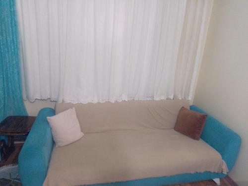 a couch with pillows sitting in front of a window at Miracle HYLen Hotel in Istanbul
