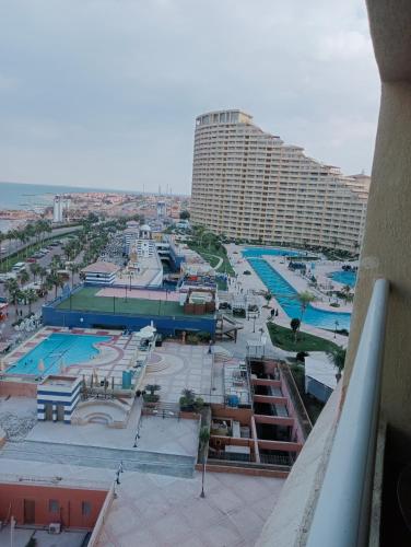 a view of a resort with a pool and a large building at اجمل شاليهات باهرامات بورتو السخنه in Suez