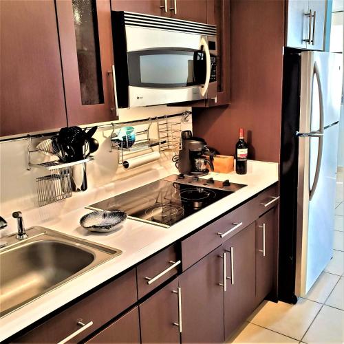 a kitchen with a sink and a microwave at KASA Seahorse of the Sea - Studio for 2 BEACH BLOCK in San Juan