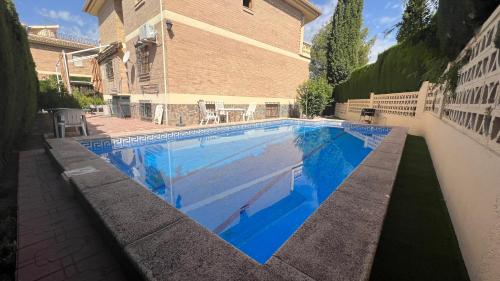 una piscina frente a un edificio en Casa Monte Verde con piscina a 10 min de Granada, en Cájar