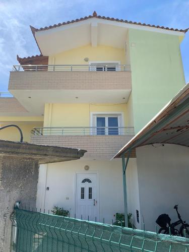 a house with a fence in front of it at A 3-floor building with 4 bedroom near beach in Fier