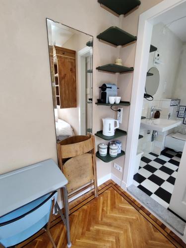 a room with a mirror and a table and a sink at House of Straw Amsterdam in Amsterdam