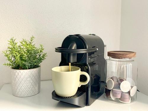 a coffee maker with a cup on a counter at StayNature 2BR App. Altstadt in Bad Reichenhall
