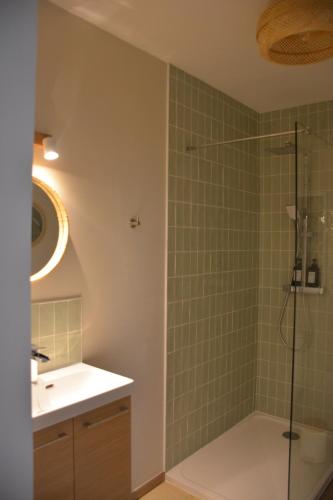 a bathroom with a shower and a sink at Domaine des cyprès in Vaudrimesnil