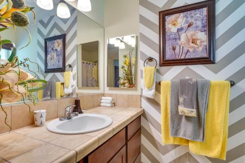 a bathroom with a sink and a mirror at Yuma Family Home with Covered Patio and Grill! in Yuma