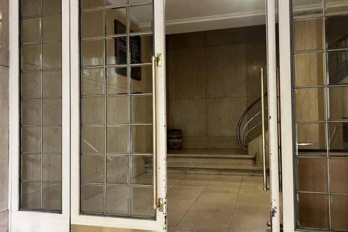 an open glass door of a room with a staircase at Downtown Buenos Aires. THE POINT in Buenos Aires