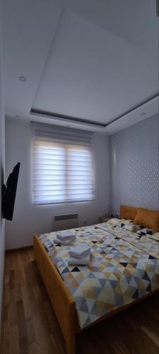 a bedroom with a large bed in a room with a window at Apartman Moj kutak Zlatibor in Zlatibor