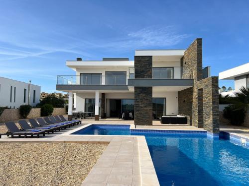 a villa with a swimming pool and a house at Luxury Modern Style Villa with Private Pool in Pêra