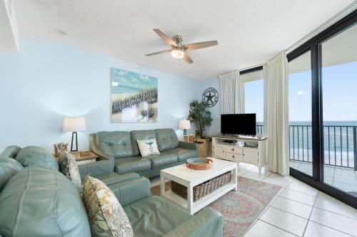 a living room with a couch and a tv at Phoenix VIII 81201 by Vacation Homes Collection in Orange Beach