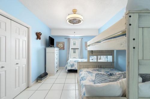 a bedroom with two bunk beds and blue walls at Phoenix VIII 81201 by Vacation Homes Collection in Orange Beach