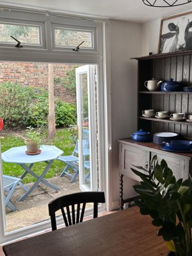a dining room with a table and a window at Charming, Renovated Residence in Willesden Green in London