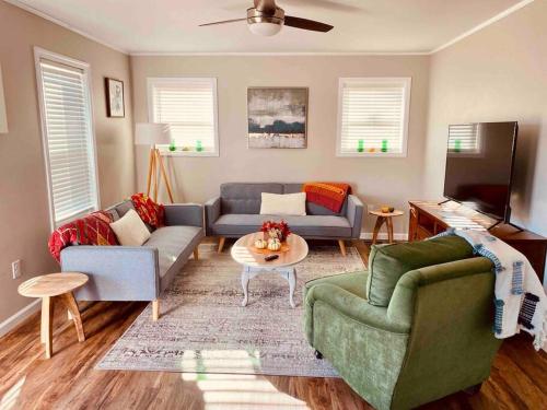 a living room with two couches and a table at Little Pet Friendly House in Greeneville