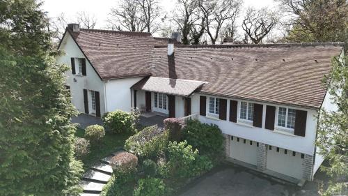 an aerial view of a white house with a roof at Domaine des cyprès in Vaudrimesnil