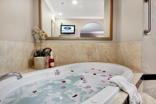 a bathroom with a bath tub with flowers on it at Best Western Plus Marina Shores Hotel in Dana Point