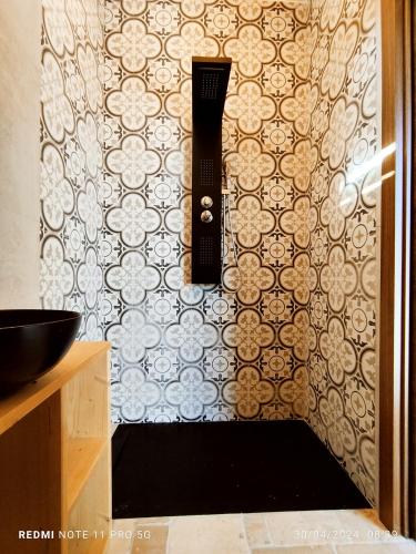 a bathroom with a shower with a wall at Alle Volte Petite Maison in Giovinazzo