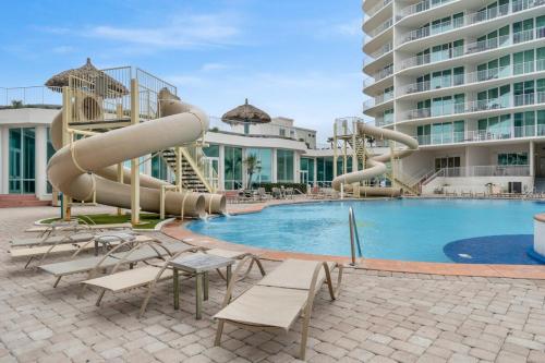 a large swimming pool with a water slide at Caribe Resort D106 by Vacation Homes Collection in Orange Beach