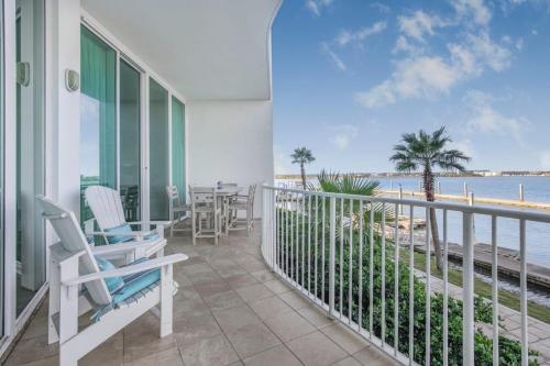 a balcony with chairs and a view of the beach at Caribe Resort D106 by Vacation Homes Collection in Orange Beach