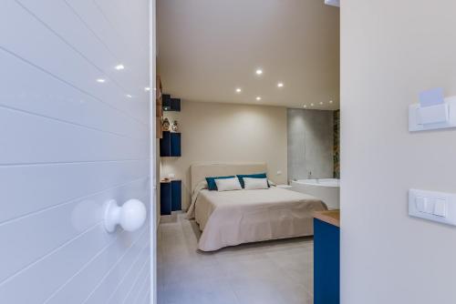 a bedroom with a bed and a tub and a sink at !!! IDROMASSAGGIO !!! - Love Suite in Sciacca